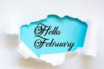 Hello February  words under torn paper
