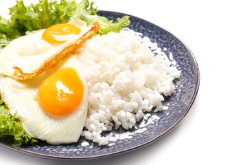 Plate with tasty eggs and rice on white background