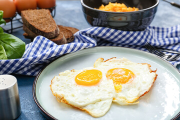 Plate with tasty eggs and rice in bowl on color background