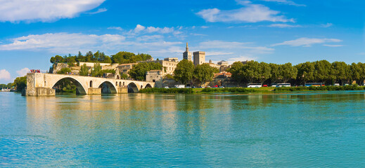 Fototapeta premium Panorama view of Avignon city with the ancient broken medieval bridge of Saint Benezet and the Rhone river on foreground (Europe-France-Provence)