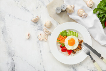 Plate with tasty egg, vegetables and rice on light background