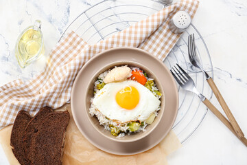 Bowl with tasty egg, vegetables and rice on table