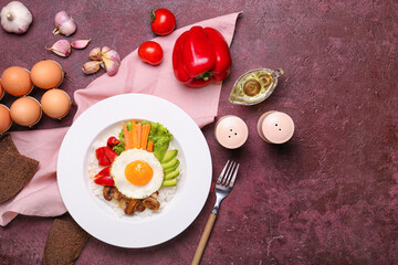 Fototapeta na wymiar Plate with tasty egg, vegetables and rice on color background