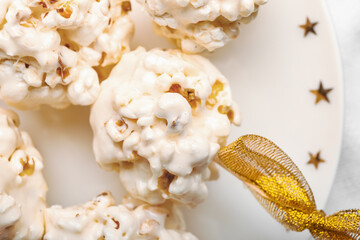 Plate with tasty popcorn balls, closeup