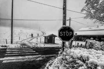 a cold winter day, a road to cross, a stop sign.