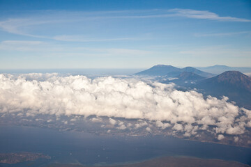 Obraz premium Mountain peaks of Indonesia, the view from the plane. Volcanoes of Indonesia, view from the plane.