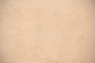 Old worn brown cardboard covered with stains.