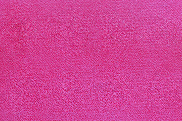 The surface of the red old worn dermatin with a small pattern.
