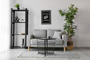 Stylish interior of living room with comfortable sofa