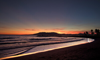 Fototapeta na wymiar sunset with mountains and mediterranean sea, orange yellow sky