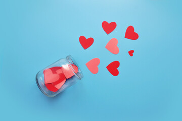 A lot of red and pink hearts fly out of the glass jar. Valentine's Day Greeting Card