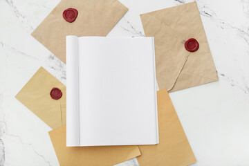 Blank magazine and envelopes on light background