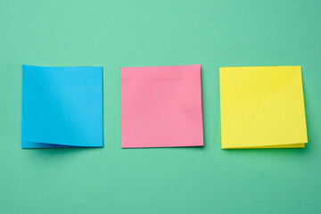 multicolored square sticks are glued to the green background