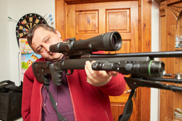 A man taking aim with rifle.
