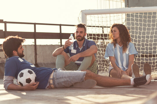 Friends hanging out after playing football