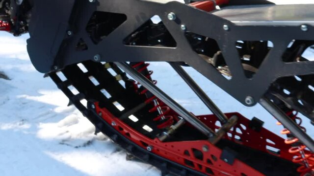 Snow motorcycles in the mountains. Snowbike details in mountain valley in beautiful snow powder. Snowdirt bike with splashes and trail. Wnter sport riding