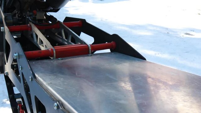 Snow motorcycles in the mountains. Snowbike details in mountain valley in beautiful snow powder. Snowdirt bike with splashes and trail. Wnter sport riding