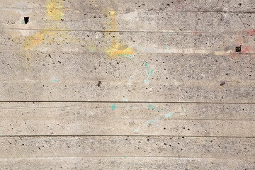 Old concrete wall background with holes left by the evaporation of the mixing water