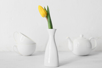 Vase with fresh tulip flower on table