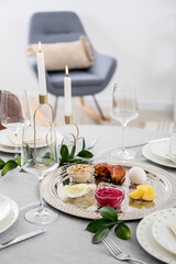 Passover Seder plate with traditional food on served table