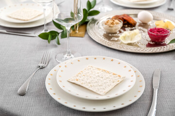 Jewish flatbread matzo on table setting for Passover Seder