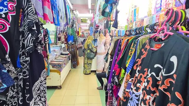 Narrow Corridor Of Shop Lots Selling Kain Batik Corak A Traditional Malaysian Clothing Style - Pan Right To Left