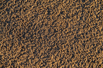 Sand surface in sunlight.