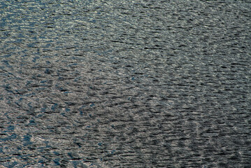 water surface in the lake is covered with fine waves.