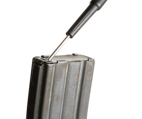 Tool prying up the bottom of an assault rifle magazine