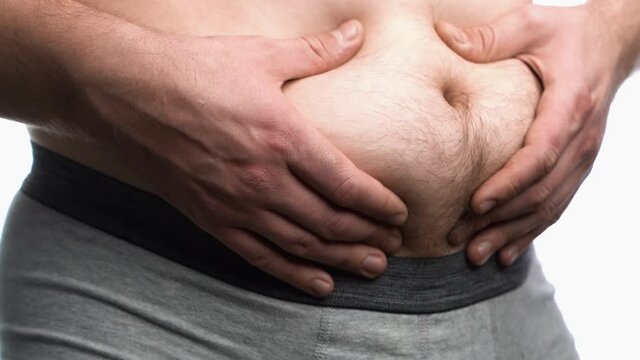 Fat belly of a man.The harm of overeating. Wrong food.
