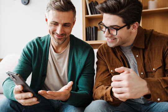 Happy Young Gay Couple Using Mobile Phone