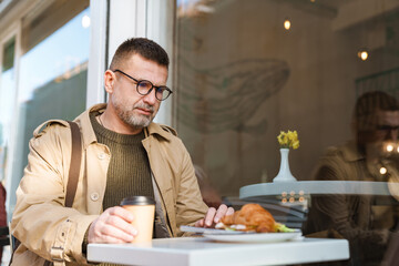 Young man texting message on smart phone while