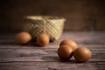 Brown chicken eggs on wooden background. Raw eggs. Fresh natural eggs.