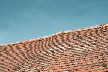 Abstract image of a house roof in contrast to the clear blue sky
