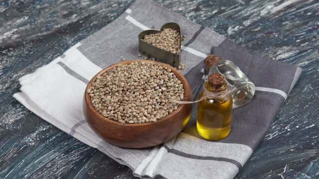 Seed hemp, oil in a glass jar, CBD cannabis oil. Alternative herbs for medicine.