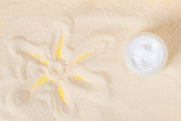 Bottle of sun block creme on sand