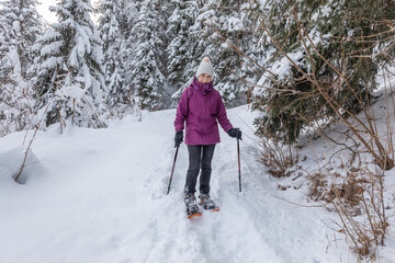 Snow shoeing in fresh snow above the pretty French Alpine village of Les Contamines-Montjoie