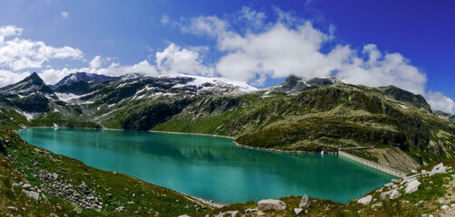 dam wall and wonderful green water from a water reservoir in the mountains panorama