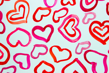 Pattern from colored painted hearts, background from watercolor paints