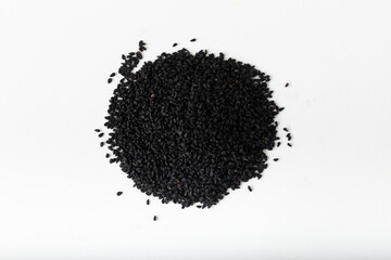 Pile of black seed on white background.