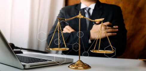Justice and law concept.Male judge in a courtroom with the gavel, working with, computer and...
