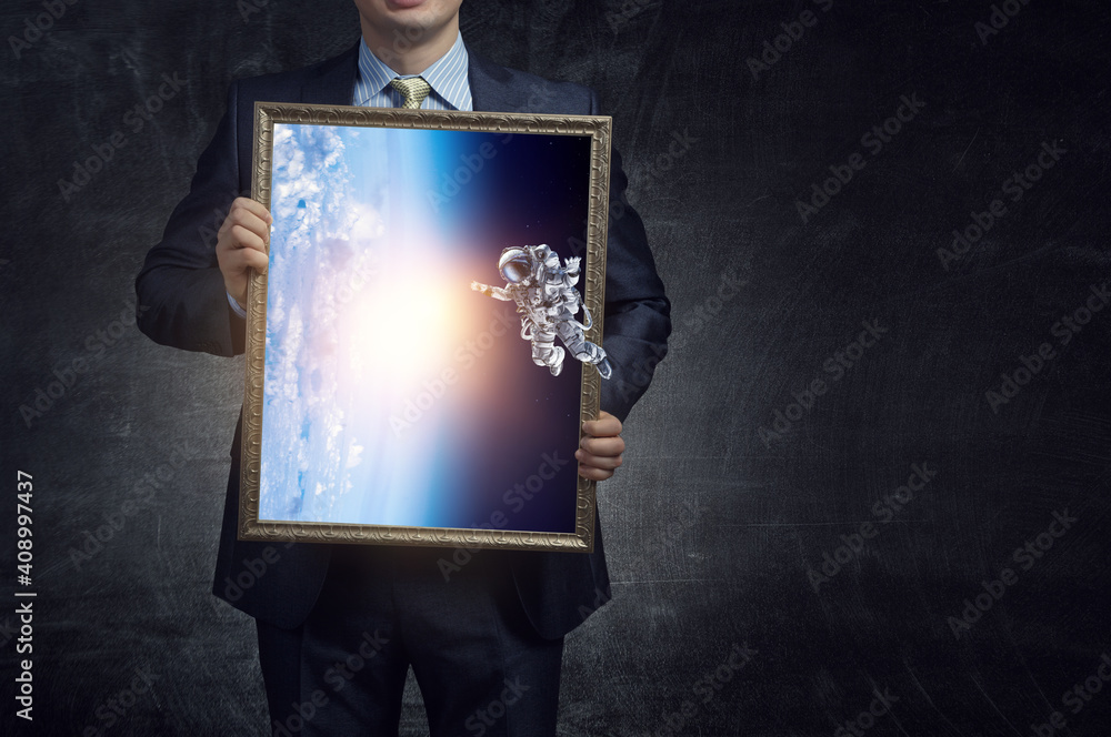 Wall mural astronaut floating in outer space
