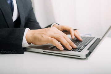 Business people use tablets and hold credit cards as an online shopping concept With a calculator and a book placed on the table