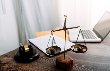 Business and lawyers discussing contract papers with brass scale on desk in office. Law, legal...