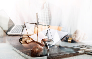 Justice and law concept.Male judge in a courtroom with the gavel, working with, computer and...