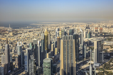 Fototapeta na wymiar Aerial view of Dubai from Burj Khalifa - tallest skyscraper in the world. DUBAI, United Arab Emirates. 