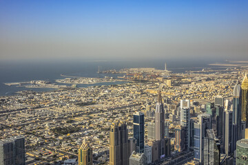 Fototapeta na wymiar Aerial view of Dubai from Burj Khalifa - tallest skyscraper in the world. DUBAI, United Arab Emirates. 