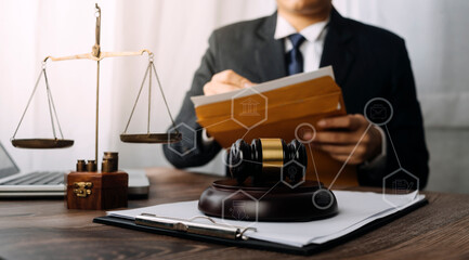 Justice and law concept.Male judge in a courtroom with the gavel, working with, computer and docking keyboard, eyeglasses, on table in morning light