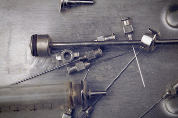 Retro nondisposable glass syringe on the dirty steel surface