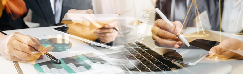 Business and lawyers discussing contract papers with brass scale on desk in office. Law, legal services, advice, justice and law concept picture with film grain effect